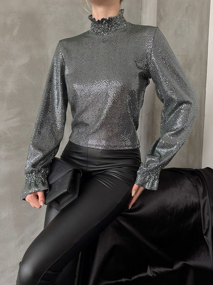 Zümrüt Gold Glitter Blouse - A stunning metallic shimmer adorns this chic blouse, showcasing a loose-fitted mock neck and elegant bishop sleeves. Versatile and modest, perfect for year-round wear.